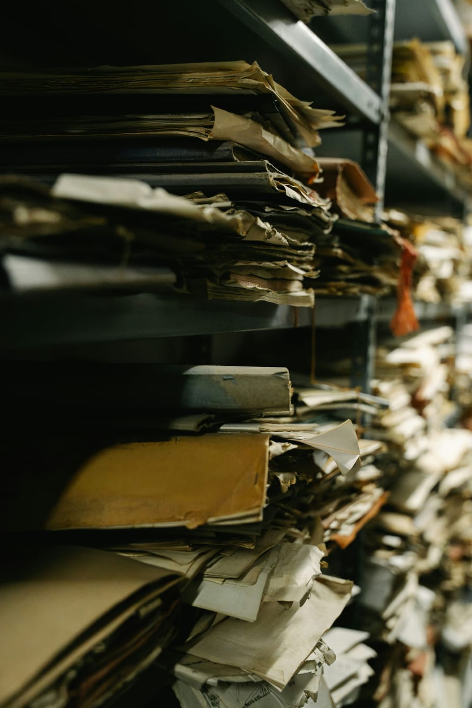 Shelves filled with old documents and papers, crammed and overflowing